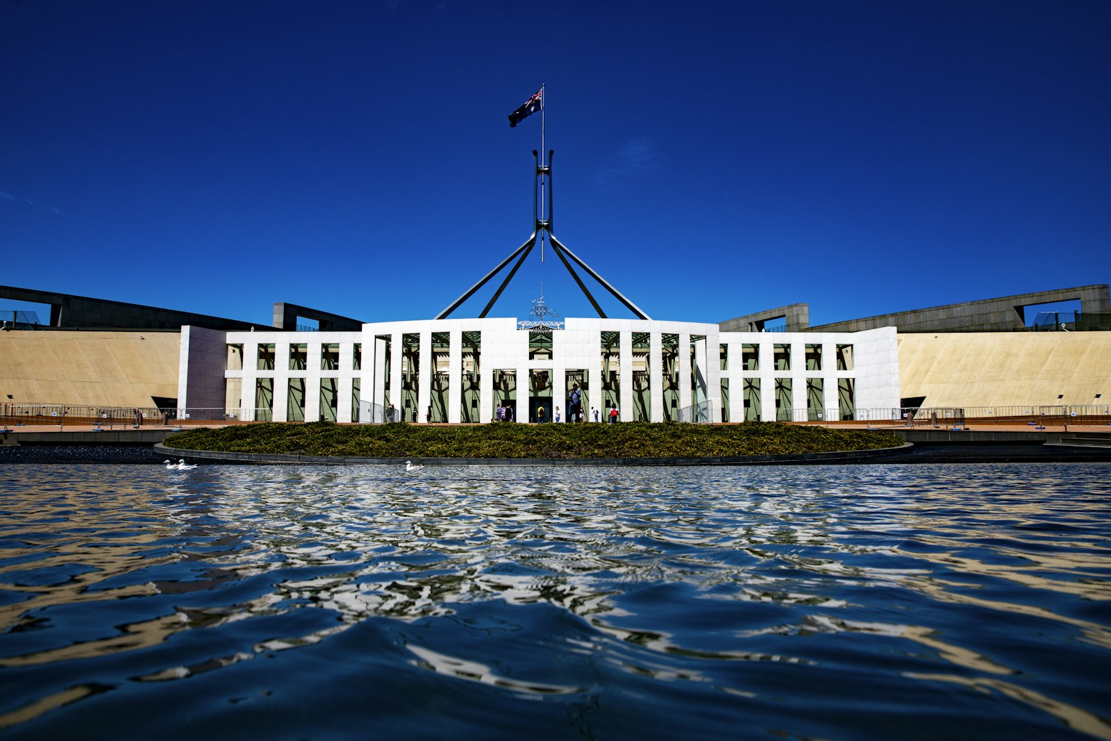 Australian Parliament House beneath its central flag mast.