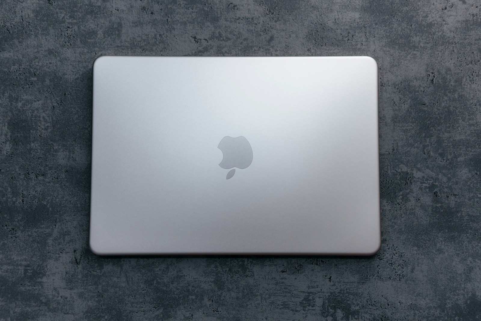 Closed silver laptop on a textured surface; illustrative, not a reported faulty product.