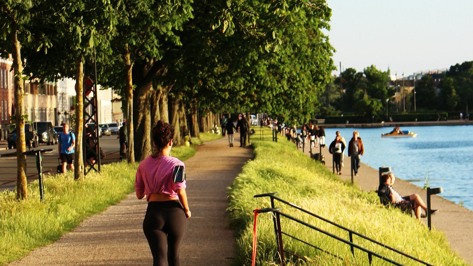 A woman jogging beside the water