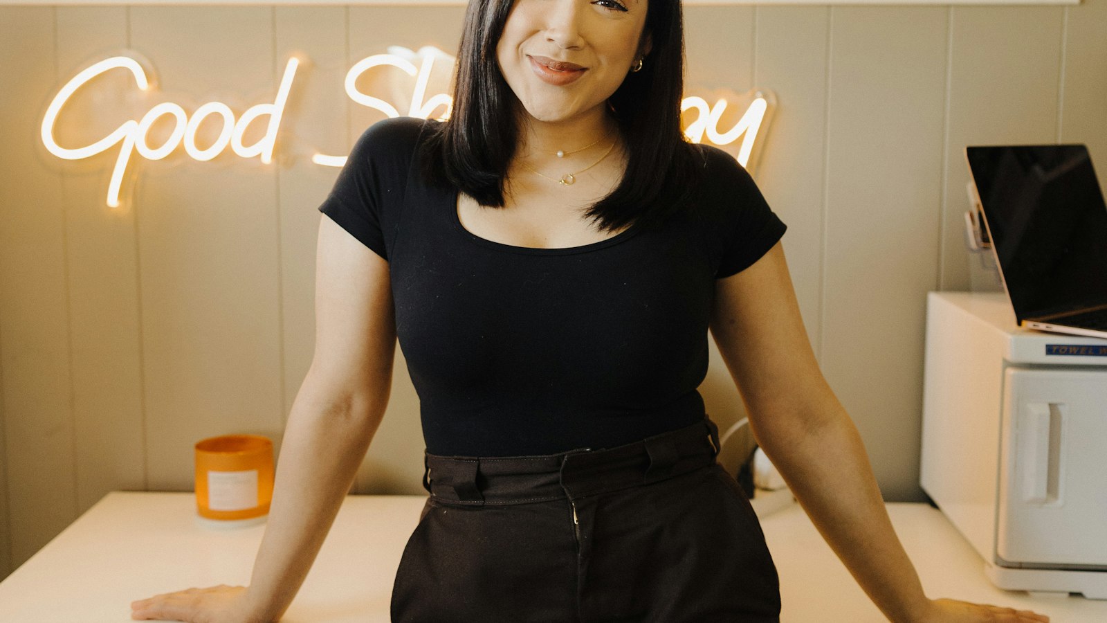 A small business owner standing at a shop counter