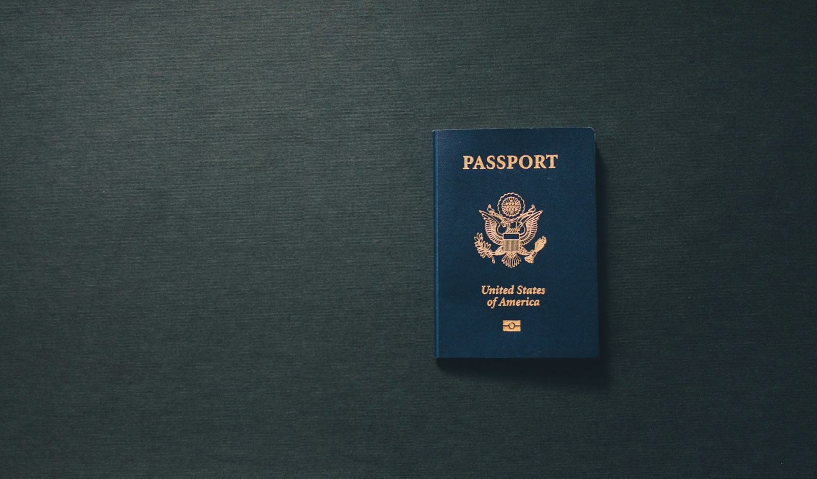 United States passport on a dark surface. Illustrative photograph, not an Australian passport.