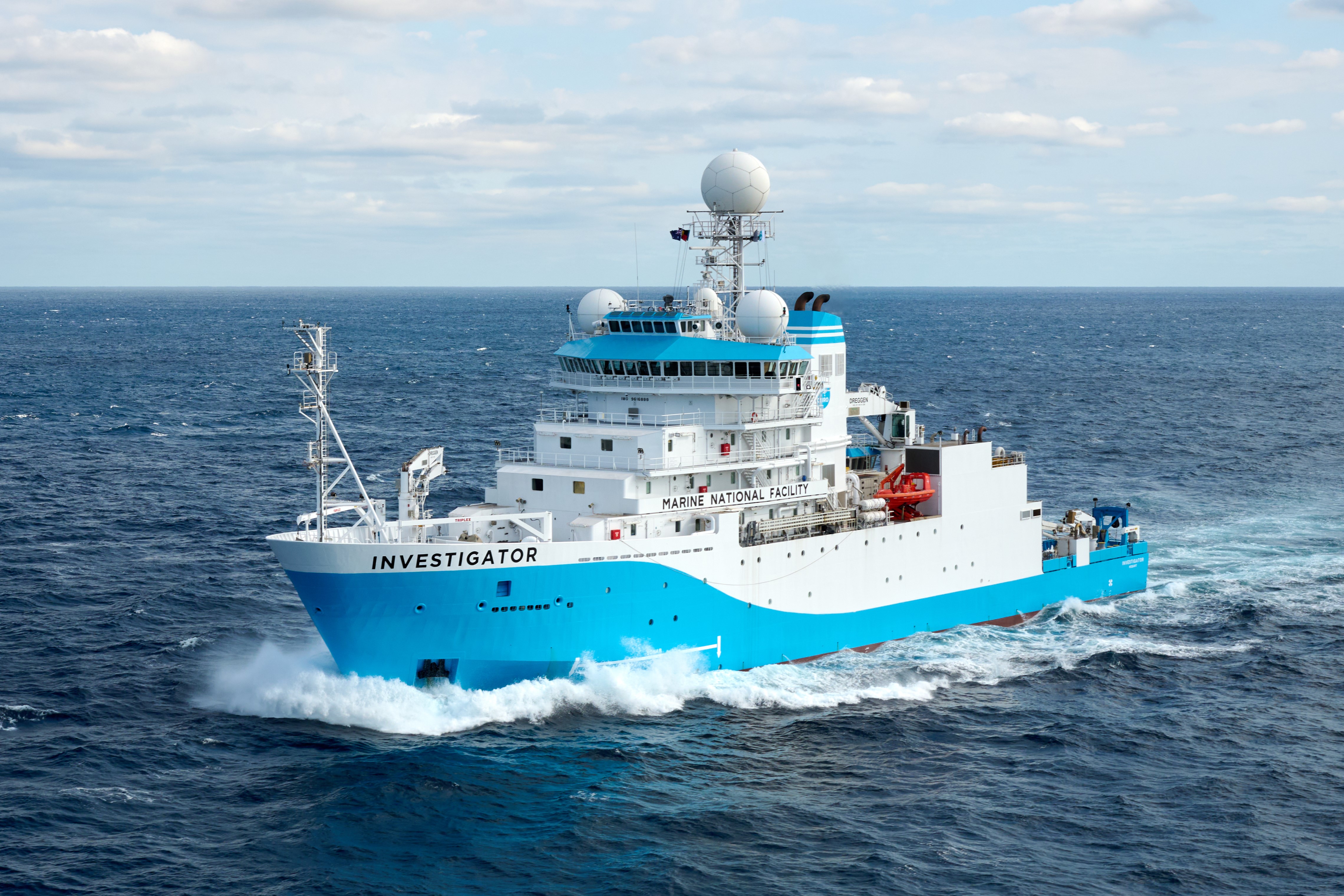 The blue and white research vessel Investigator at sea.