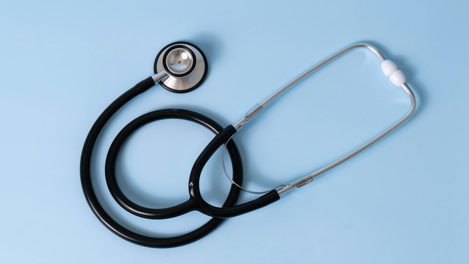 A stethoscope on a light blue background