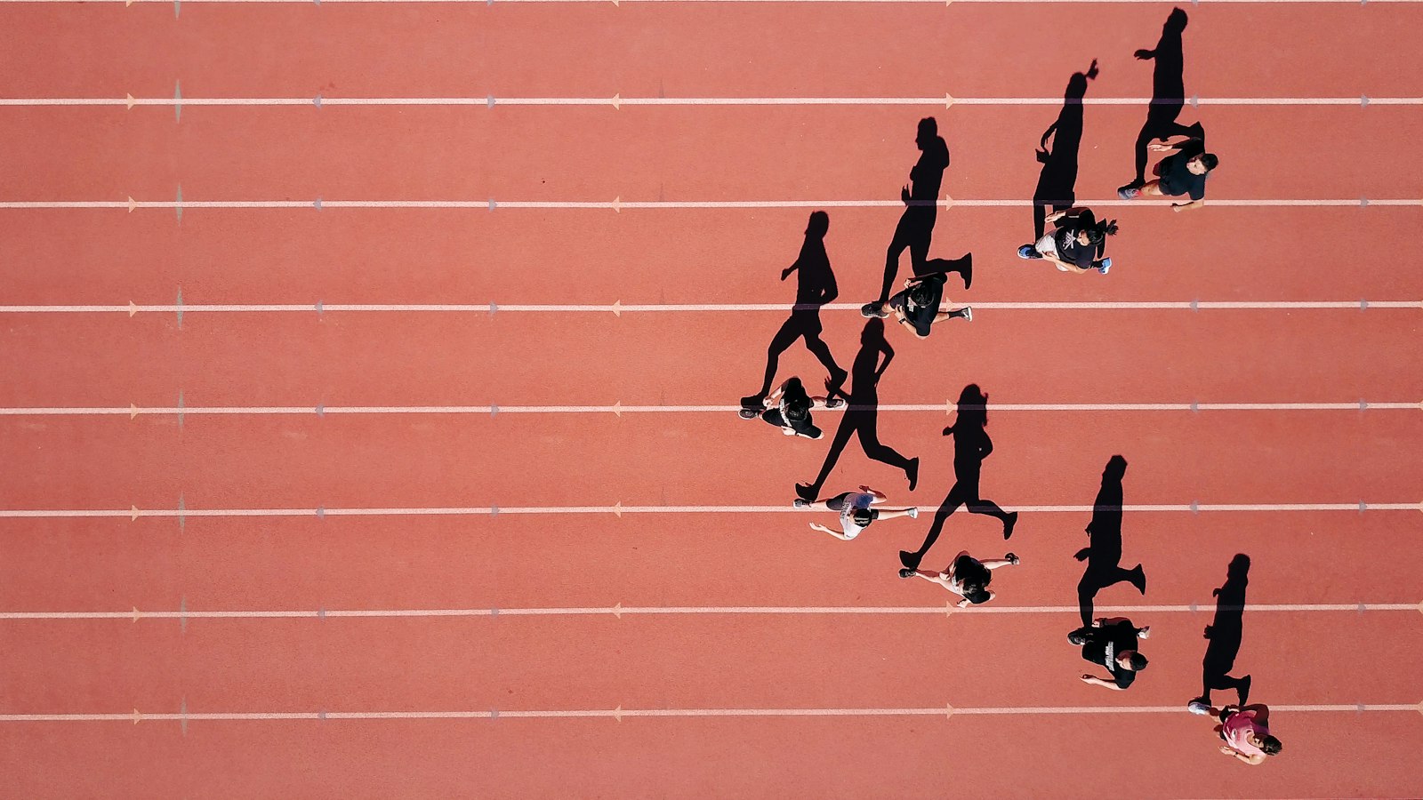 Athletes running on a stadium track