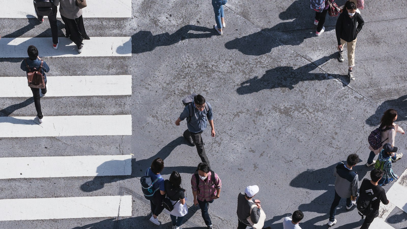 Aerial view of people crossing a busy pedestrian crossing
