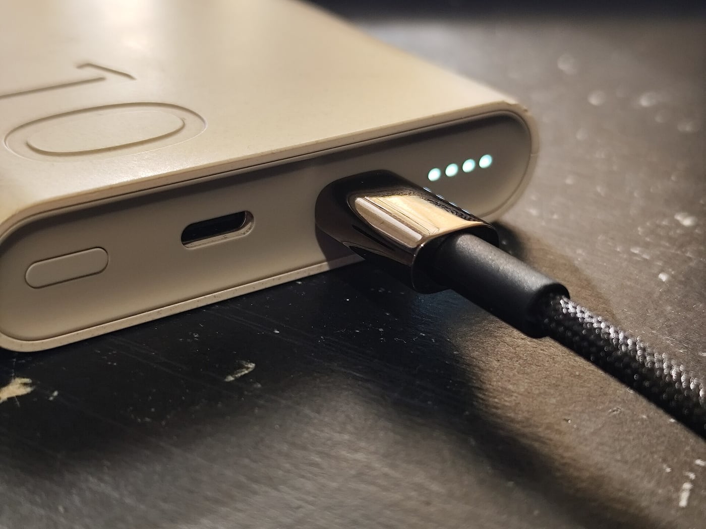 A USB-C cable connected to a portable power bank.
