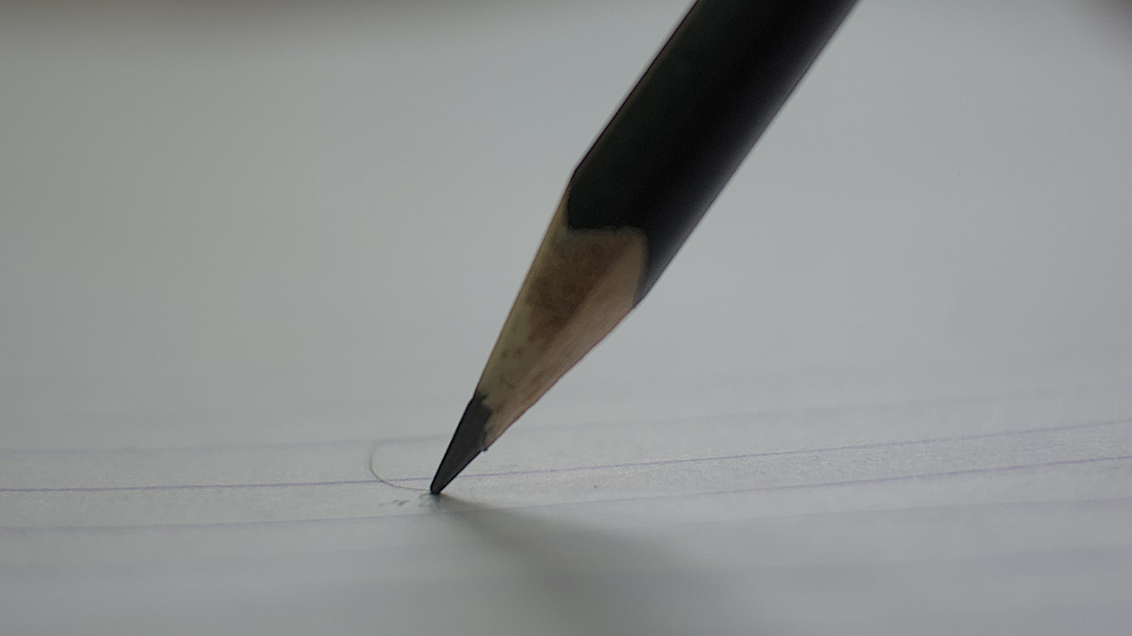 A pencil writing on paper